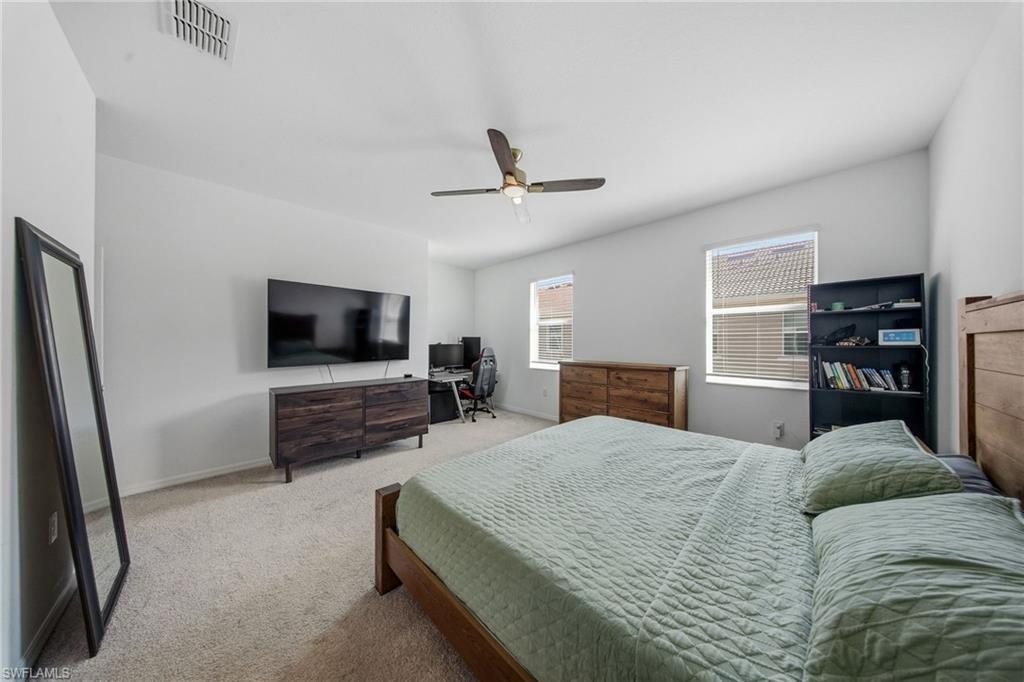 2930 Citrus Street Naples, FL 34120 - Photo 23 of 35 a bedroom with a bed and a flat screen tv