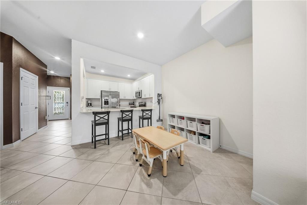 2930 Citrus Street Naples, FL 34120 - Photo 4 of 35 a view of a kitchen with dining area and entryway