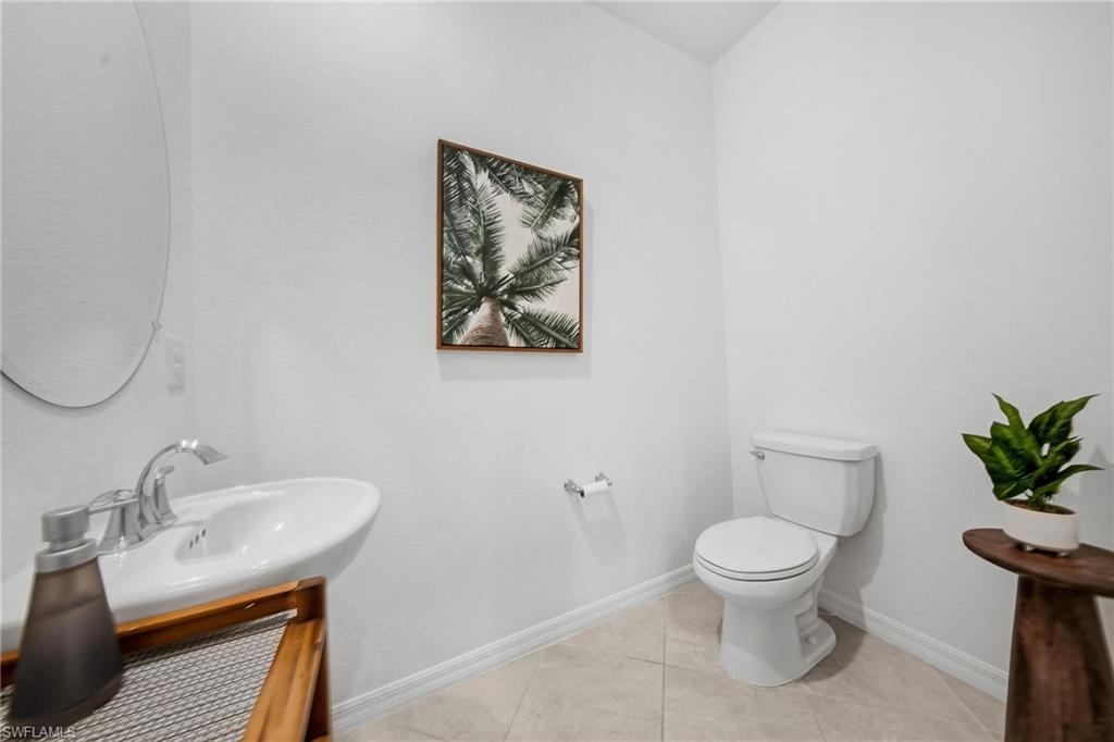 2930 Citrus Street Naples, FL 34120 - Photo 7 of 35 a white toilet sitting next to a bathroom sink