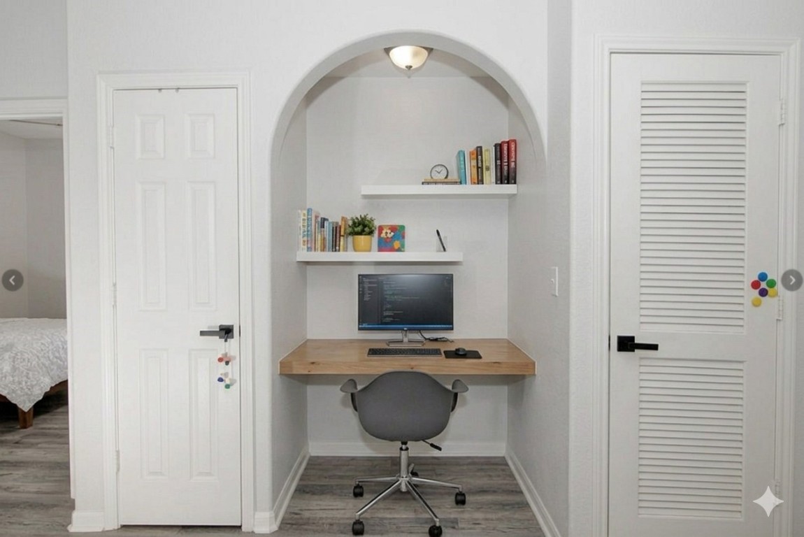 1441 East Street, Unit 212 Houston, TX 77007 - Photo 6 of 6 a view of a hallway with cabinet and a potted plant