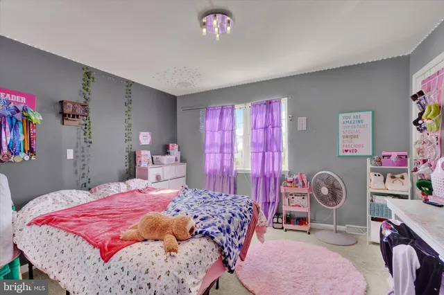 a bedroom with a bed dresser and a window