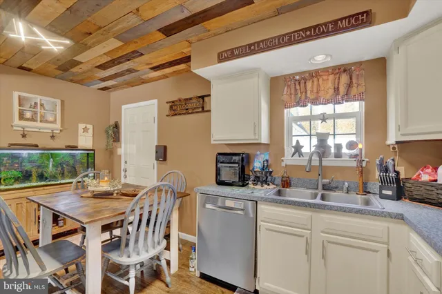 a kitchen with a table chairs stove and cabinets
