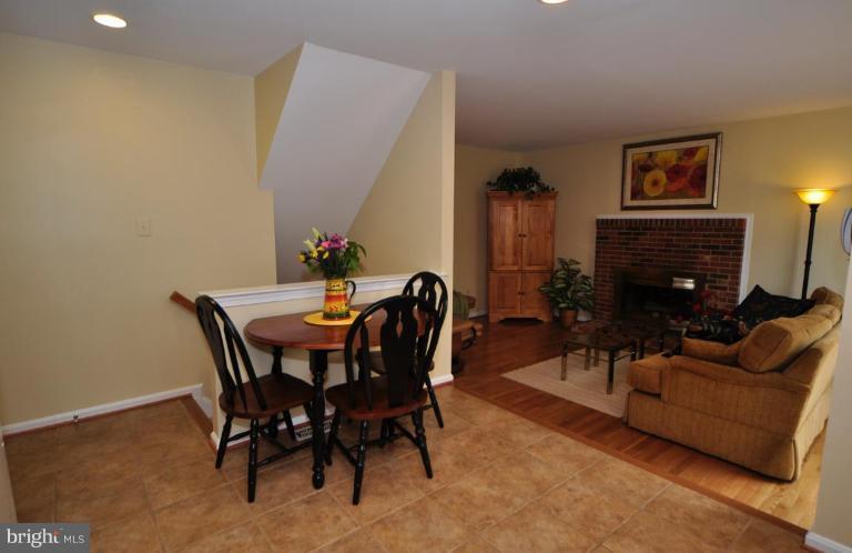 812 Potomac Ridge Court Sterling, VA 20164 - Photo 17 of 30 a living room with furniture a fireplace and a flat screen tv