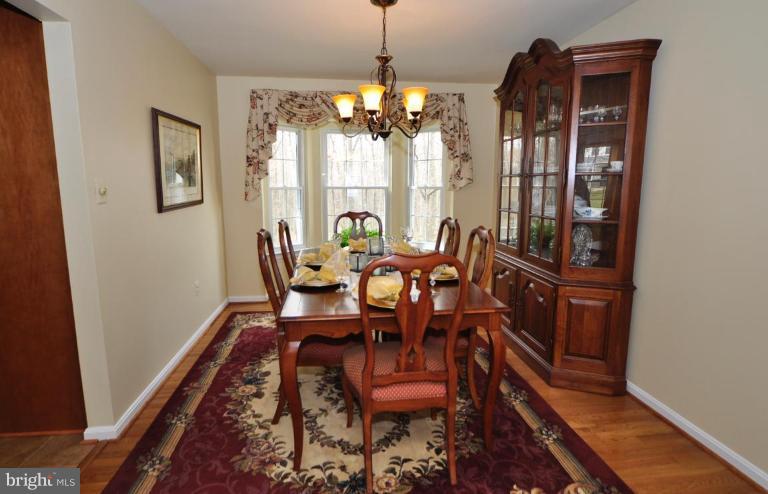 812 Potomac Ridge Court Sterling, VA 20164 - Photo 4 of 30 a dining room with furniture a chandelier and wooden floor