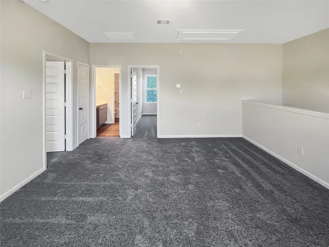 an empty room with a window and a mirror