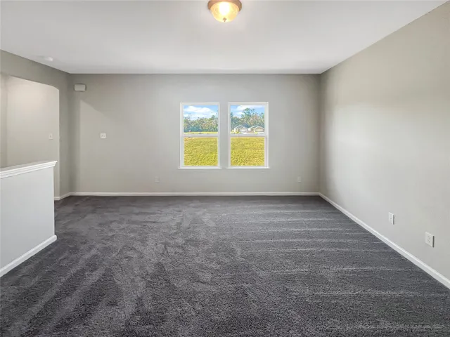 an empty room with a white walls next to a window