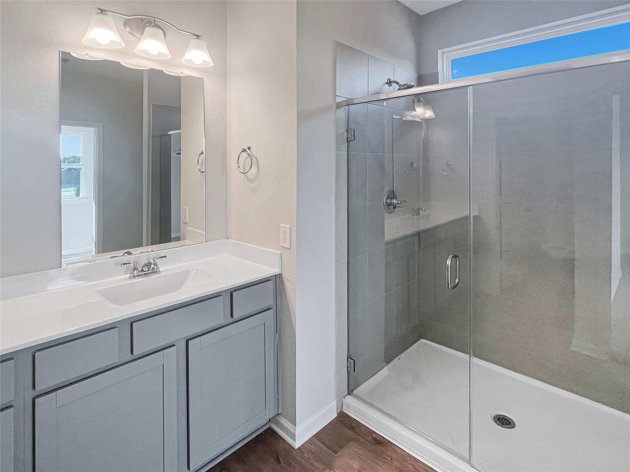 9758 Enclave Ridge Road Willis, TX 77318 - Photo 17 of 25 a bathroom with a shower sink and mirror