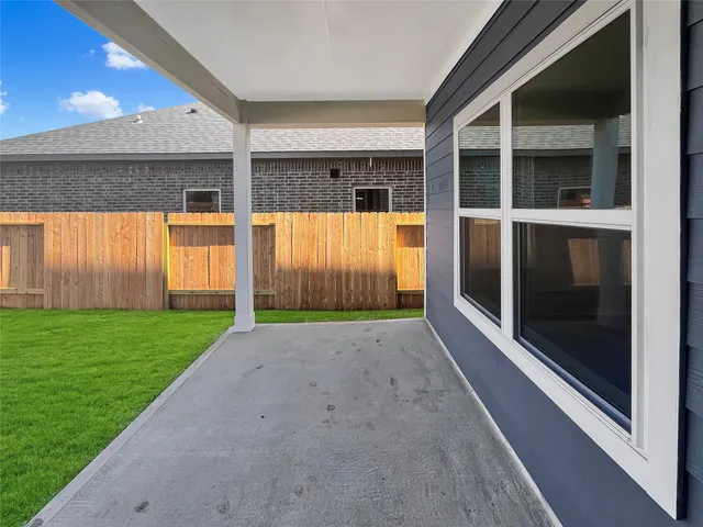 a view of an house with backyard and balcony