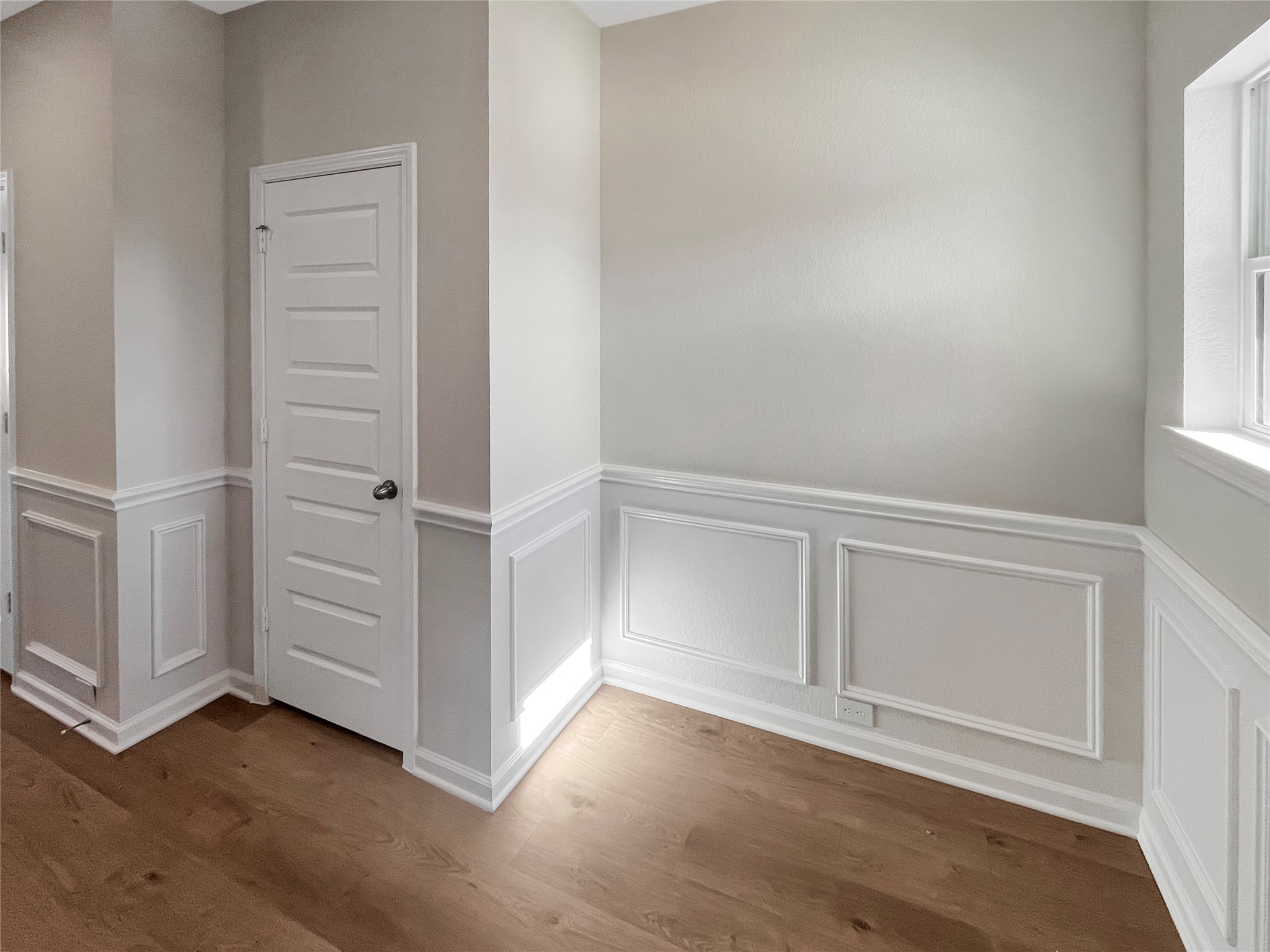 9758 Enclave Ridge Road Willis, TX 77318 - Photo 4 of 25 an empty room with wooden floor cabinet and windows