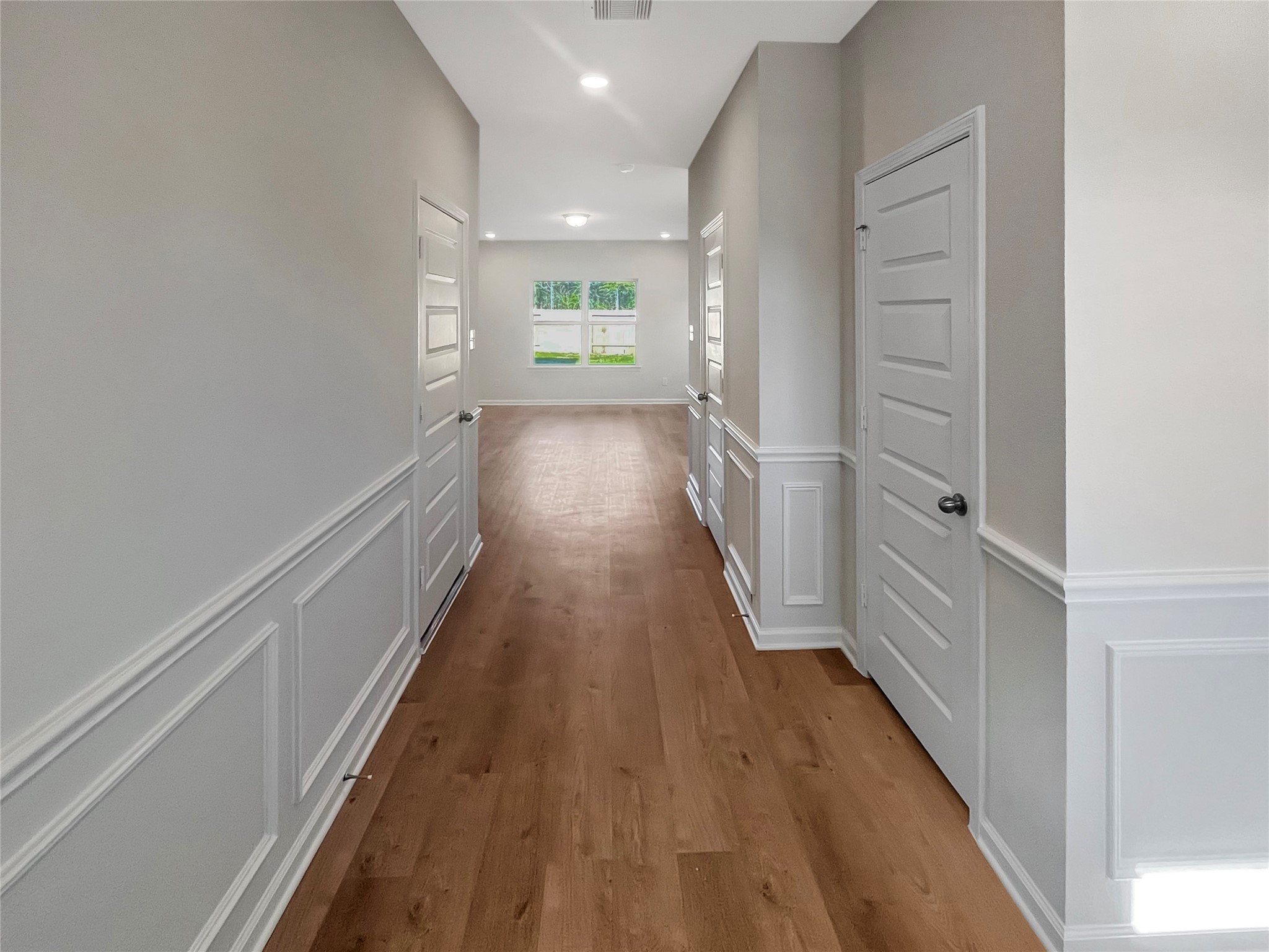 9758 Enclave Ridge Road Willis, TX 77318 - Photo 5 of 25 a view of a hallway with wooden floor