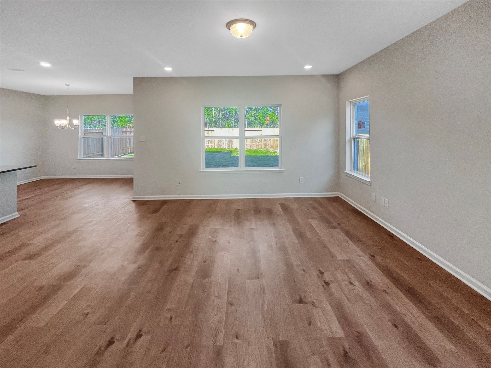 9758 Enclave Ridge Road Willis, TX 77318 - Photo 6 of 25 an empty room with wooden floor and windows