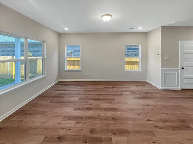 an empty room with windows and closet