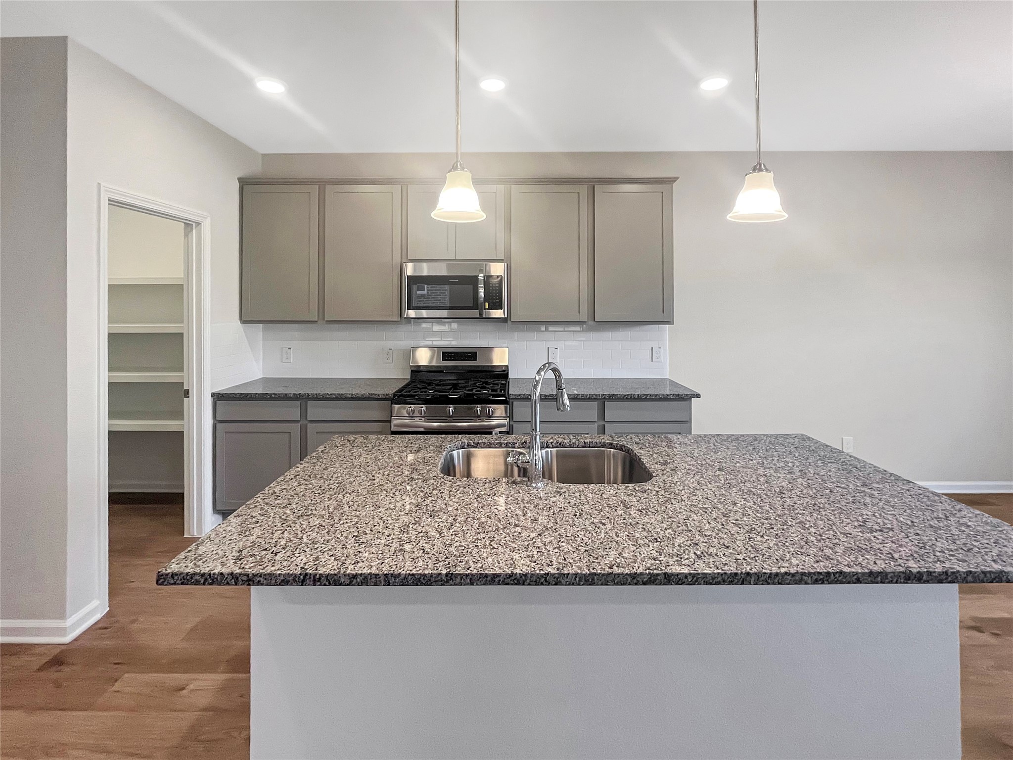 9758 Enclave Ridge Road Willis, TX 77318 - Photo 8 of 25 a kitchen with stainless steel appliances granite countertop a sink stove and refrigerator