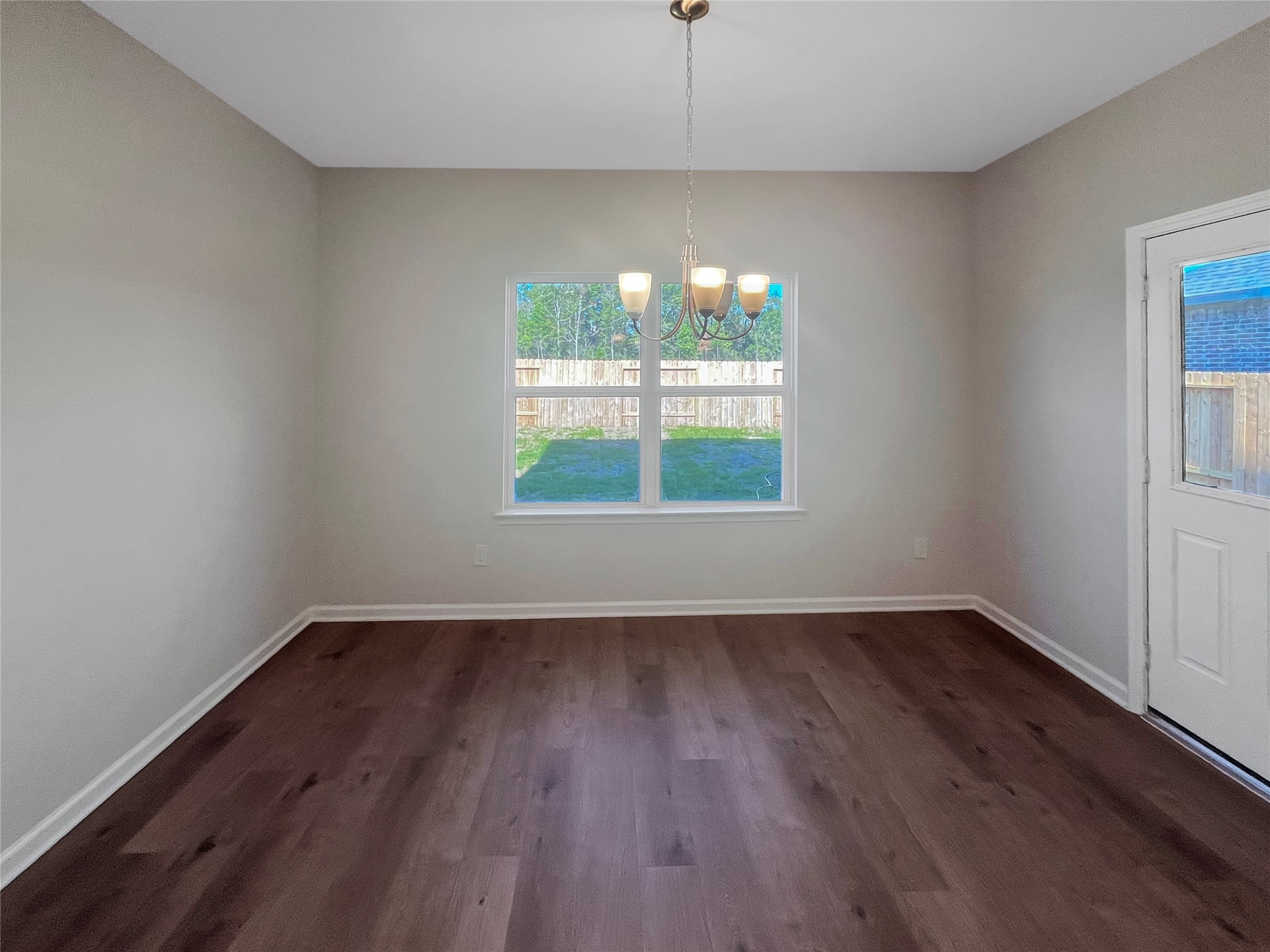 9758 Enclave Ridge Road Willis, TX 77318 - Photo 10 of 25 an empty room with wooden floor and windows