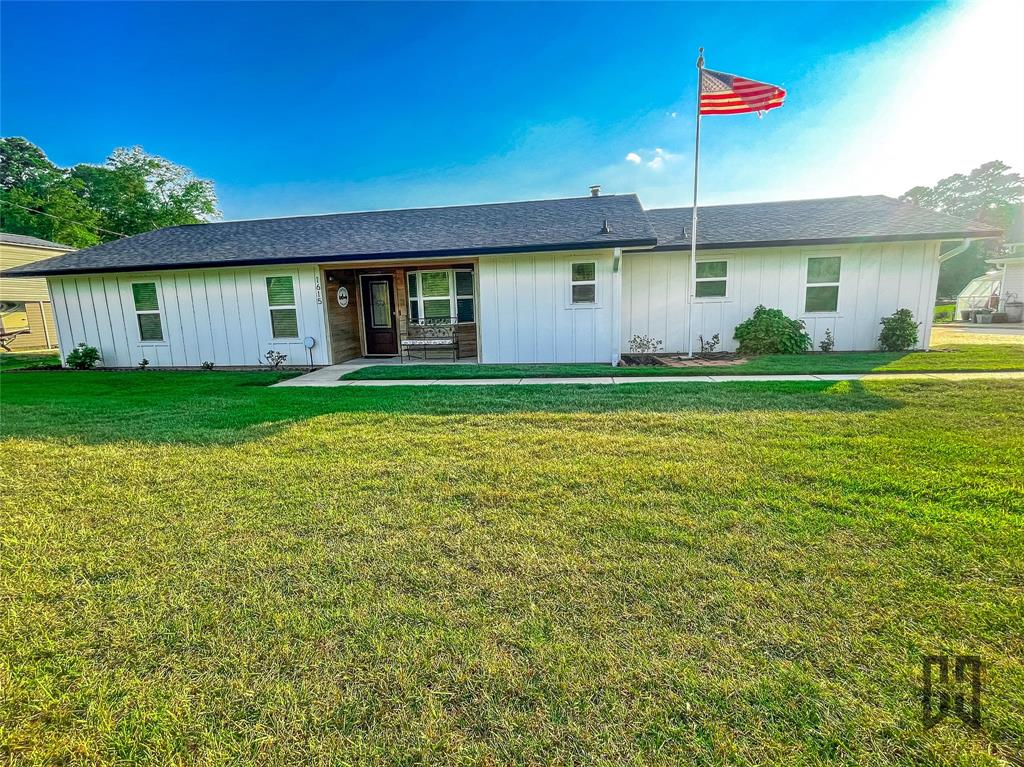 1615 Airport Loop Homer, LA 71040 - Photo 1 of 35 a front view of a house with a yard and potted plants