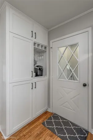 a view of a closet area with wooden floor