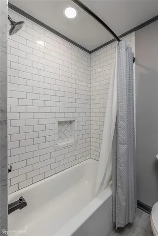 a bathroom with a bathtub and a shower