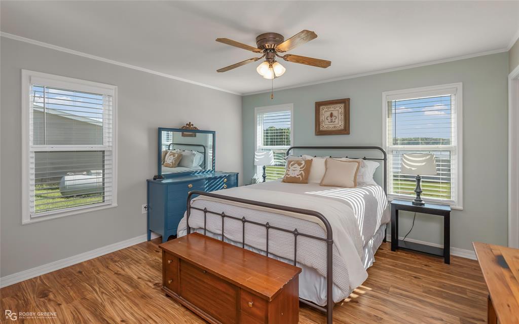 1615 Airport Loop Homer, LA 71040 - Photo 26 of 35 a bedroom with a bed and a table with chair