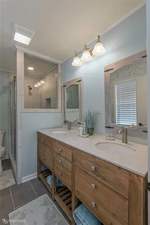 a bathroom with a double vanity sink and a mirror