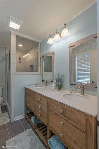 a bathroom with a double vanity sink and a mirror