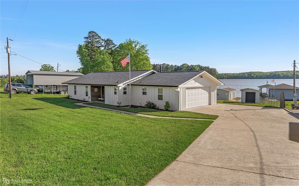 1615 Airport Loop Homer, LA 71040 - Photo 32 of 35 a front view of a house with a yard and garage