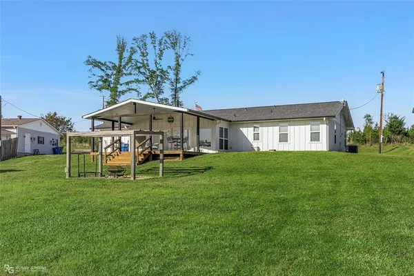 a view of a house with a yard porch and sitting area
