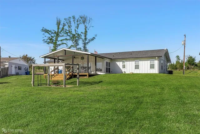 a view of a house with a yard porch and sitting area