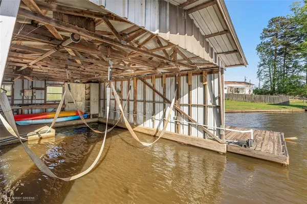 a view of a swimming pool with a patio and a yard