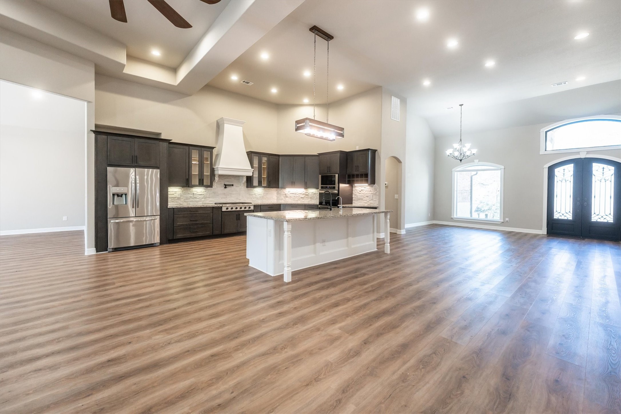 2172 Greentree Drive Huntsville, TX 77340 - Photo 12 of 45 Open kitchen with soaring ceilings, designer lighting, and a spacious island.