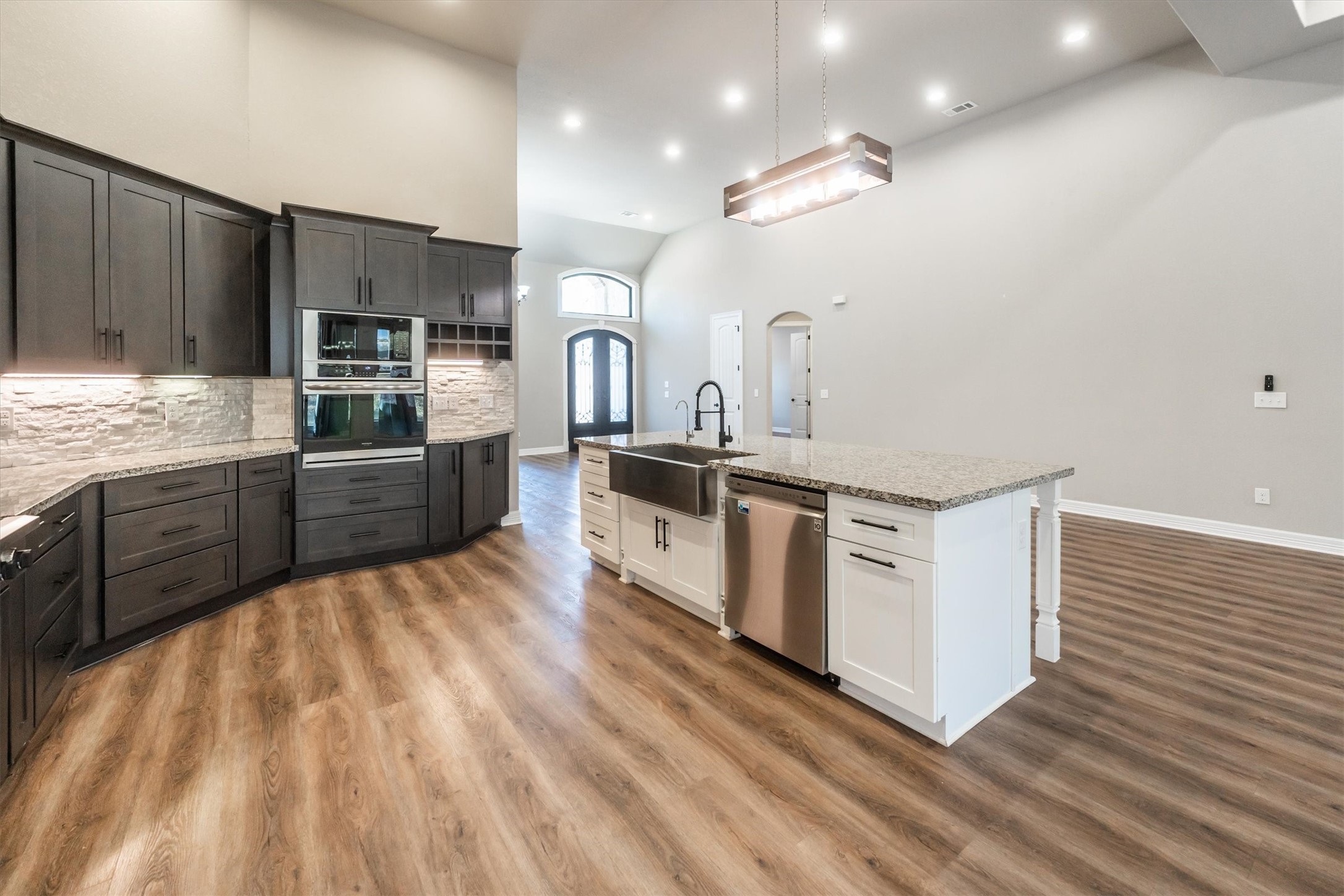 2172 Greentree Drive Huntsville, TX 77340 - Photo 14 of 45 Kitchen island with sink, storage, stainless steel appliances, and dishwasher.