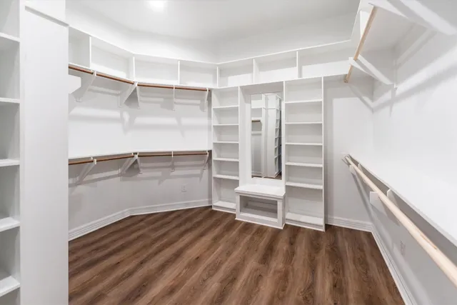 a view of walk in closet with empty racks