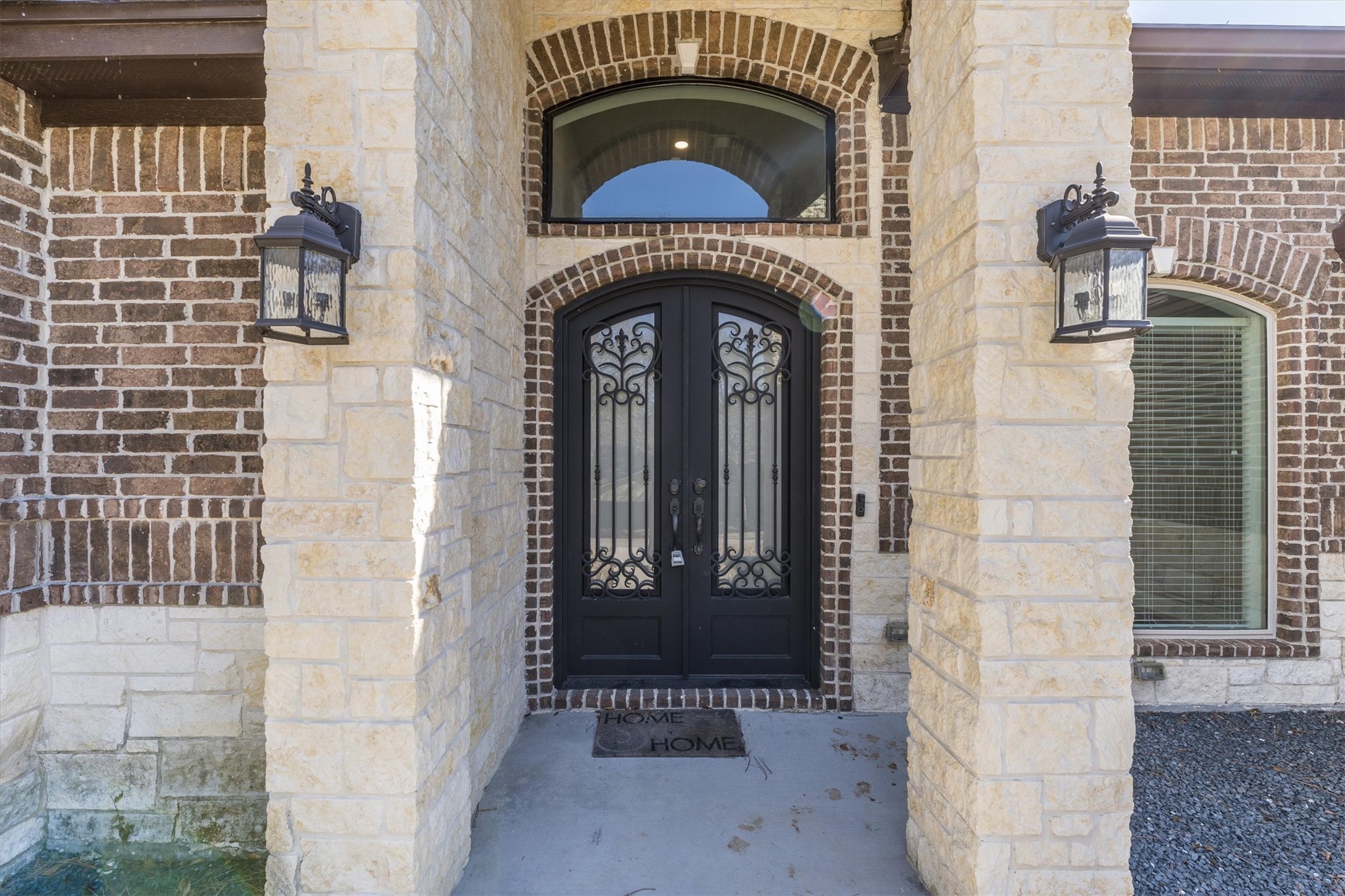 2172 Greentree Drive Huntsville, TX 77340 - Photo 4 of 45 Inviting front door accented by exterior lighting, creating a warm and welcoming entry.