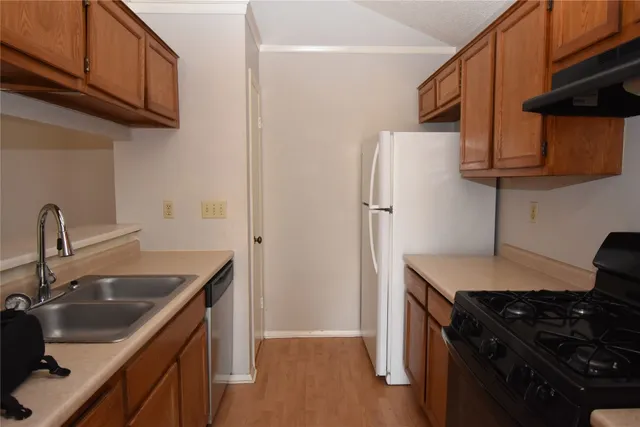 a kitchen with stainless steel appliances granite countertop a sink stove and refrigerator