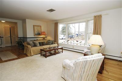 249 Holly Point Road Centerville, MA 02632 - Photo 12 of 20 a living room with furniture and a large window