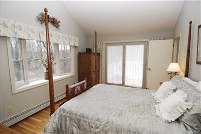 249 Holly Point Road Centerville, MA 02632 - Photo 13 of 20 a bedroom with a large bed and a window
