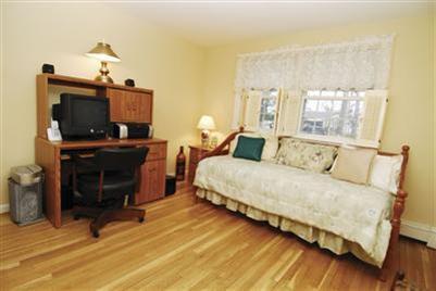249 Holly Point Road Centerville, MA 02632 - Photo 17 of 20 a bedroom with a bed and a flat screen tv