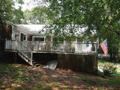 249 Holly Point Road Centerville, MA 02632 - Photo 3 of 20 a view of a deck with a bench