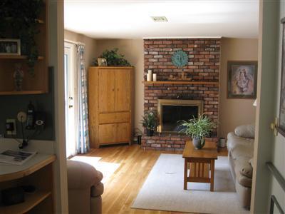 249 Holly Point Road Centerville, MA 02632 - Photo 6 of 20 a living room with furniture and a fireplace
