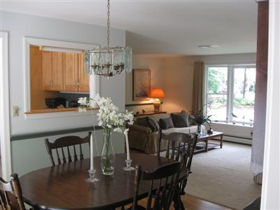 249 Holly Point Road Centerville, MA 02632 - Photo 8 of 20 a dining room with furniture a chandelier and window
