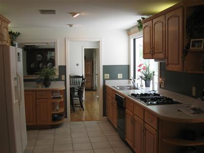 249 Holly Point Road Centerville, MA 02632 - Photo 9 of 20 a kitchen with stainless steel appliances granite countertop a stove refrigerator and cabinets