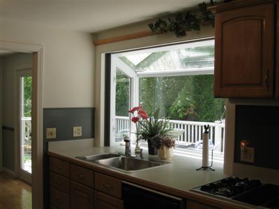 249 Holly Point Road Centerville, MA 02632 - Photo 10 of 20 a kitchen with a sink and wooden floor