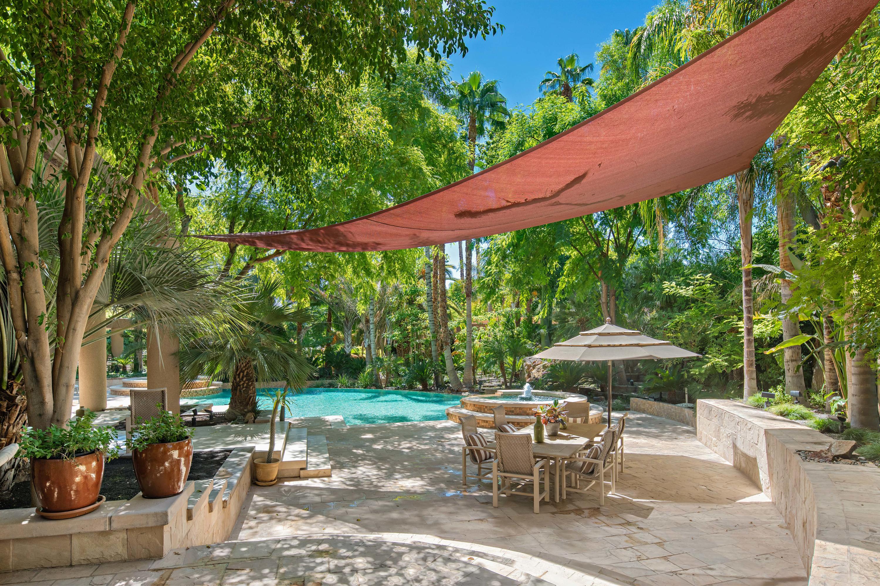 3 Mozart Lane Rancho Mirage, CA 92270 - Photo 1 of 41 a patio with a table and chairs under an umbrella