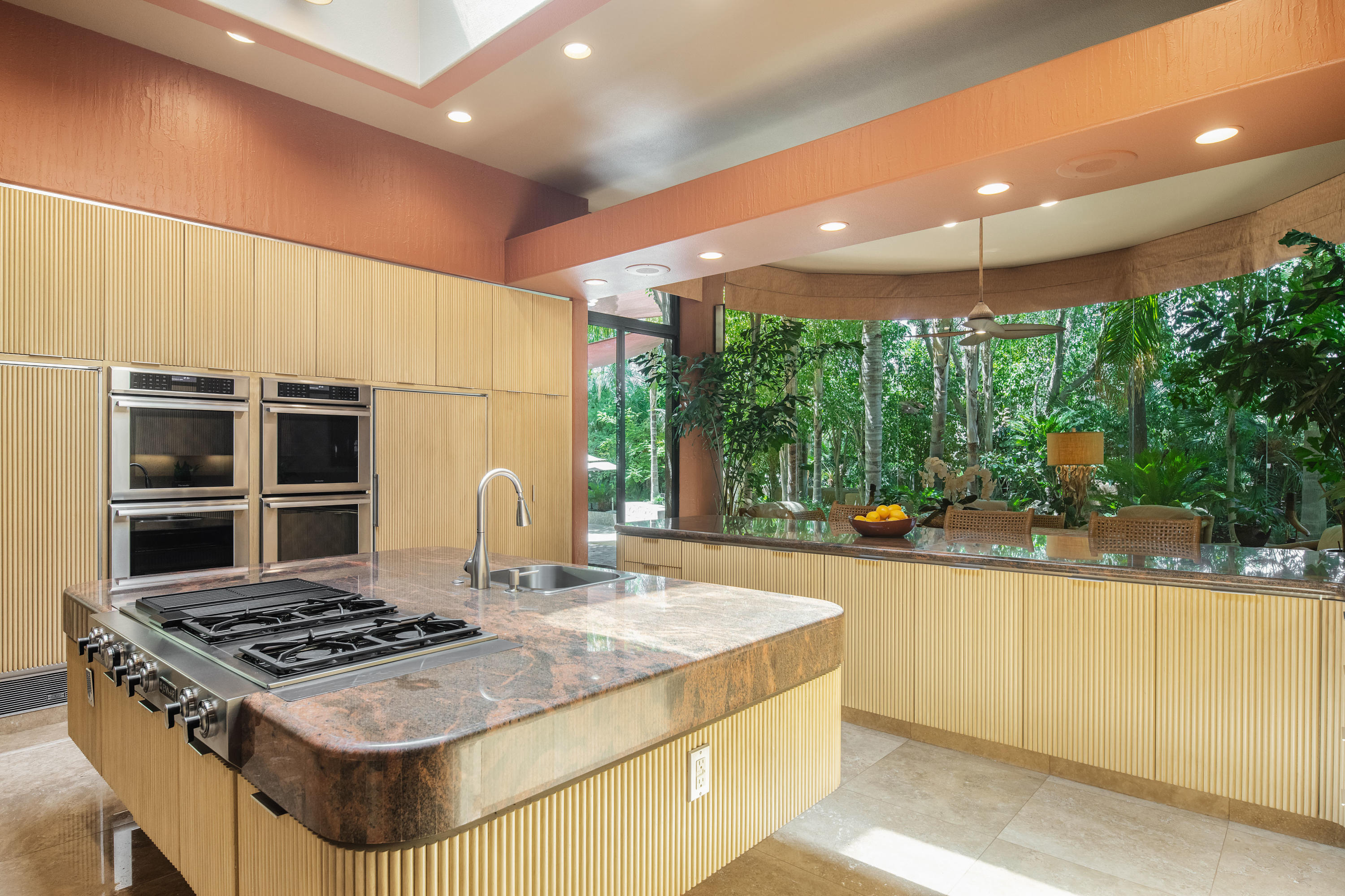 3 Mozart Lane Rancho Mirage, CA 92270 - Photo 11 of 41 a kitchen with kitchen island a stove and a large window