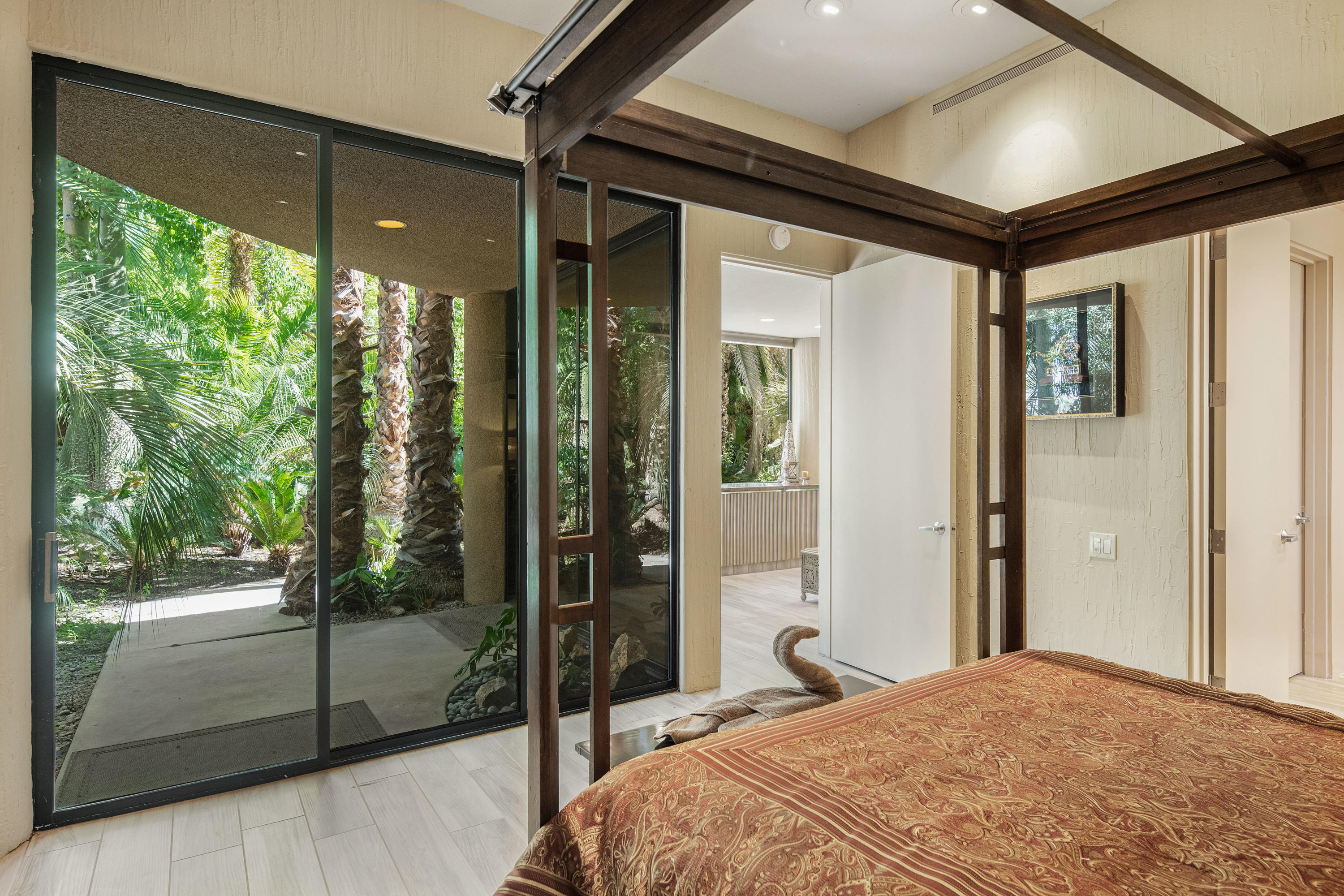 3 Mozart Lane Rancho Mirage, CA 92270 - Photo 28 of 41 a bedroom with a large bed and a glass door