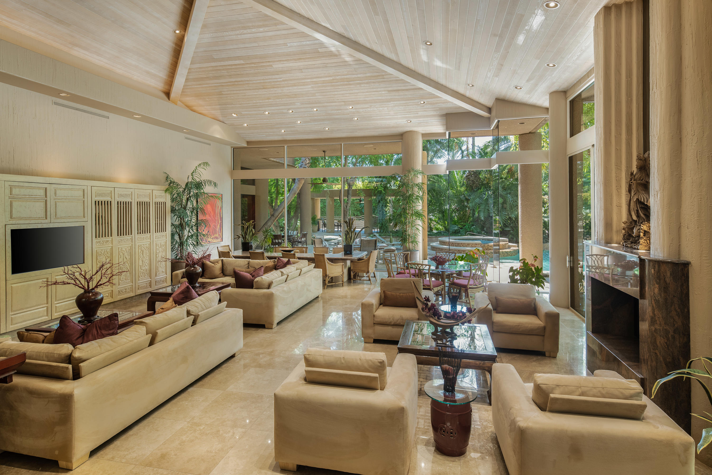 3 Mozart Lane Rancho Mirage, CA 92270 - Photo 7 of 41 a living room with furniture large windows and a flat screen tv