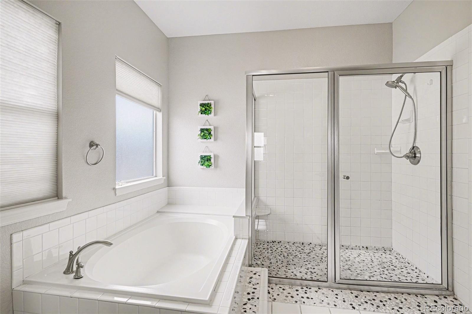 12271 West Chenango Drive Morrison, CO 80465 - Photo 13 of 37 a bathroom with a bathtub and a shower