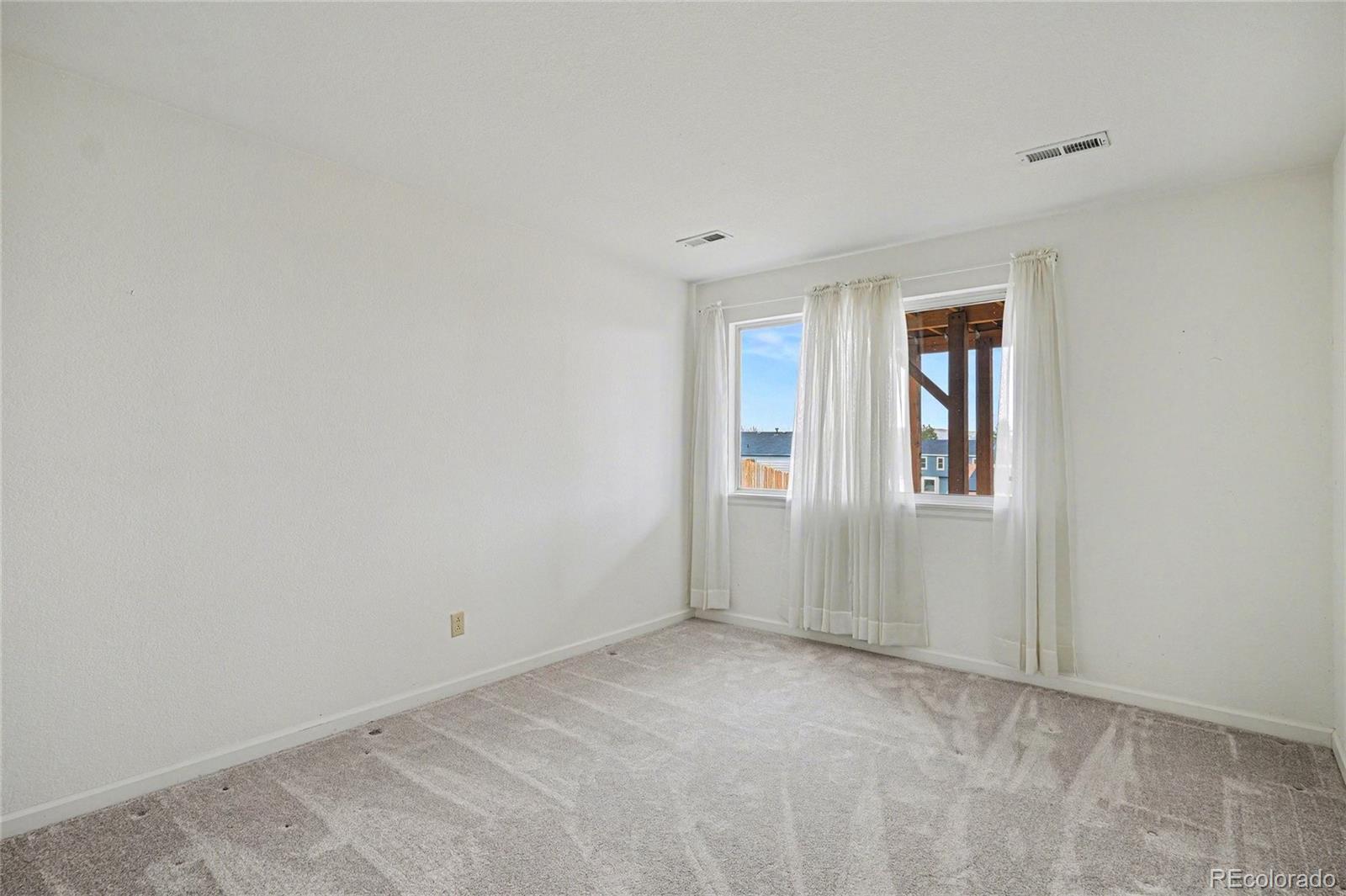12271 West Chenango Drive Morrison, CO 80465 - Photo 15 of 37 a view of an empty room with a window