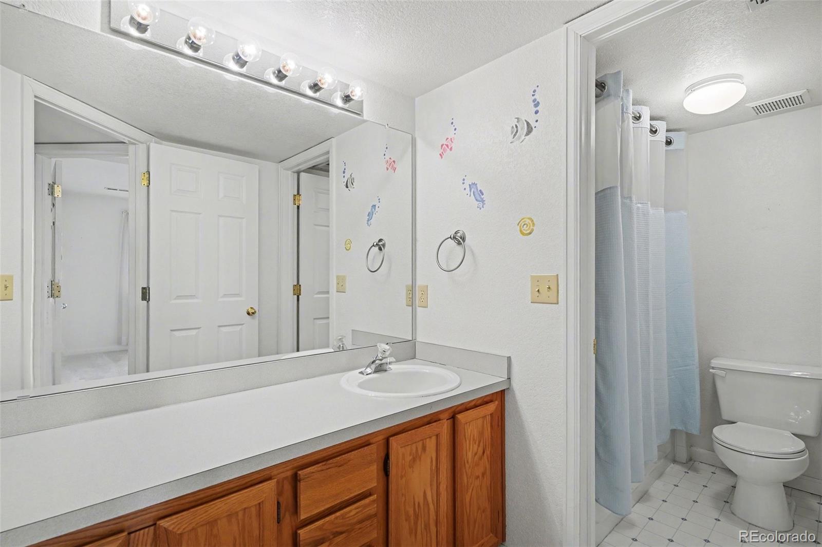 12271 West Chenango Drive Morrison, CO 80465 - Photo 18 of 37 a bathroom with a sink and a mirror
