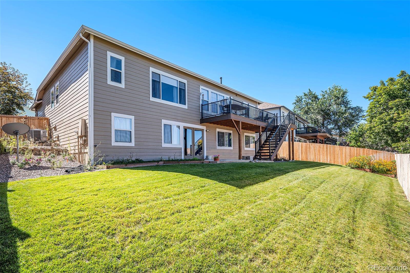 12271 West Chenango Drive Morrison, CO 80465 - Photo 28 of 37 a house view with swimming pool in front of it
