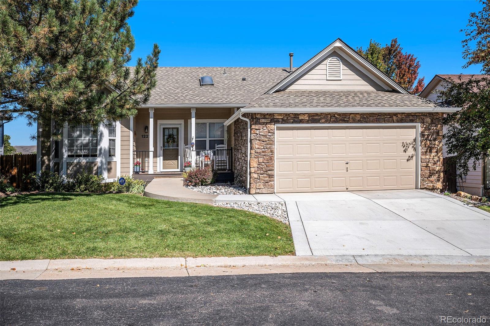 12271 West Chenango Drive Morrison, CO 80465 - Photo 29 of 37 a front view of a house with a yard and garage